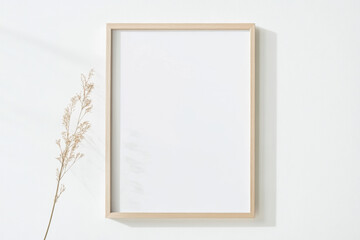 Obraz premium A simple frame mockup on a white background, with a thin, light-colored wooden frame and a blank canvas inside the picture frame.