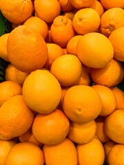 Freshly harvested oranges piled high in a vibrant display at the local market