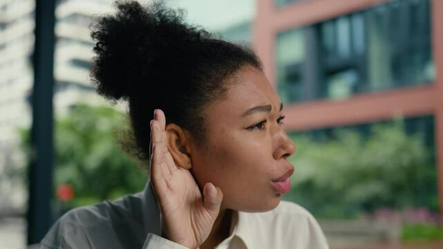 African American woman bad dont hearing quiet sound whisper female girl businesswoman portrait lady holding hand ear asking question deaf face listen health medicine business city outdoor gesture what