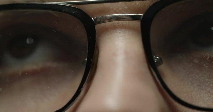 Close-Up of Eyes Wearing Glasses in Dramatic Lighting