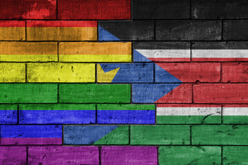 colourful painted big flag of south sudan and rainbow gay pride flag on a massive old brick wall...