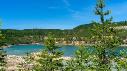 Abandoned Lipovsky nickel quarry near of city Rezh, Sverdlovsk region, the Urals with turquoise...