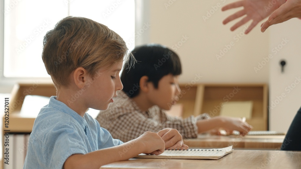 Poster side view of caucasian elementary student looking a note and answer question while sitting in front 