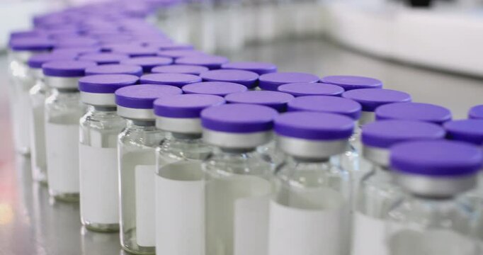 Pharmaceutical industry conveyor moving empty vial bottles