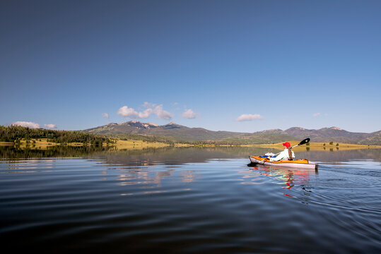 USA, Colorado. Woman kayaking on Steamboat Lake. (MR)