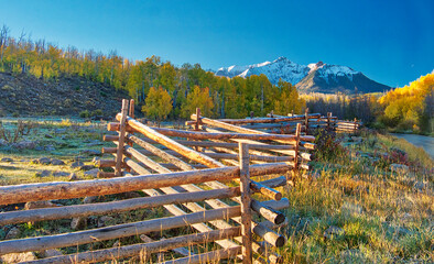 USA, Colorado, Quray. Dallas Divide, sunrise on the Mt. Snaffles with autumn colors and split rail fence