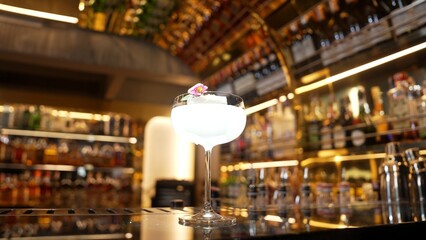 Closeup mixed creamy vodka cocktail glass decorated flower preparation, making special drink menu to VIP guest at front bar luxury. Special refresh drink showcasing nightlife at nightclub. Vinosity.