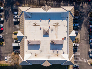 Sunny Day Time Drone Images of a TPO Roof on a Commercial Building.
