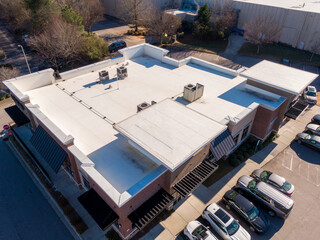 Sunny Day Time Drone Images of a TPO Roof on a Commercial Building.