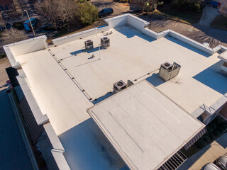 Sunny Day Time Drone Images of a TPO Roof on a Commercial Building. © Oak City Drone