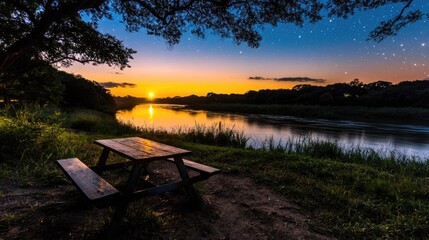 Sunset picnic table by tranquil river under starry sky