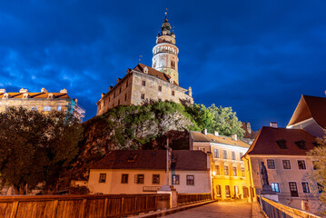 Fototapeta premium Cesky Krumlov Castle Tower stands majestically at night, showcasing its historical architecture under bright lights.