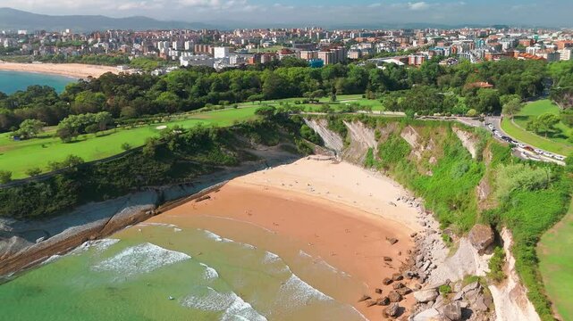 Beautiful green coast of Santander with high cliffs and sandy beach, Spain.