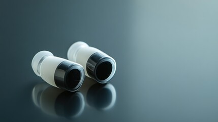 Fototapeta premium White black earplugs studio shot, reflective surface, noise reduction, audio
