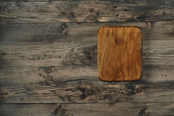 A beautifully crafted wooden cutting board is placed on a rustic wooden table, showcasing its...