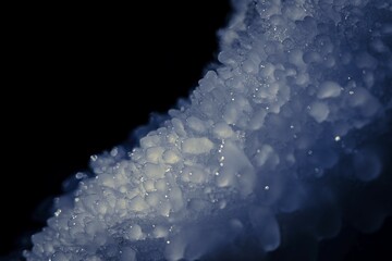Frozen ice crystals in close-up with blue tint