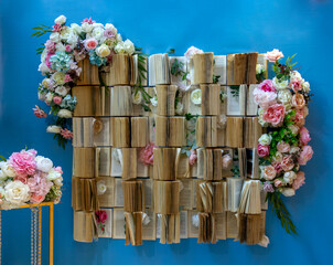 installation photo zone on the wall many open books decorated with flowers