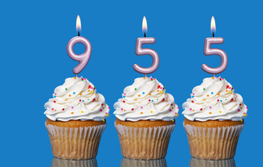 Birthday Cupcakes With Candles Lit Forming The Number 955
