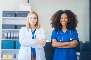 Young African American and Russian woman, both scientists, collaborate to analyze blood samples,...