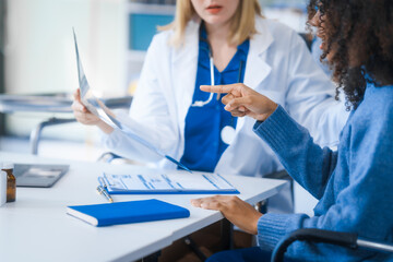 A young African American patient consults with a young Russian medical doctor about her immune...