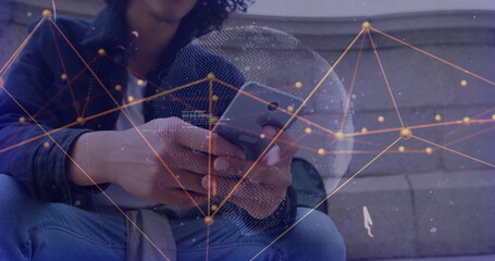 Image of data processing and globe over biracial man using smartphone