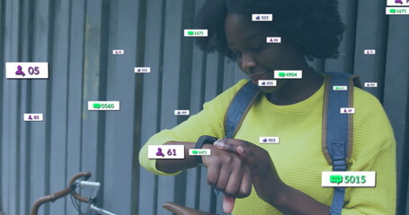 Image of icons and data processing over african american woman using smartwatch