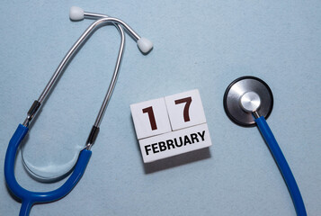 A close-up of a wooden block calendar displaying the date February 17