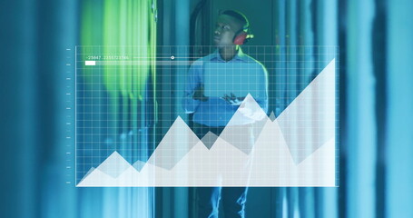 Image of financial data processing over african american businessman working in server room