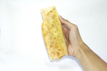 A person holding a Kebab, a Middle Eastern specialty on a white background