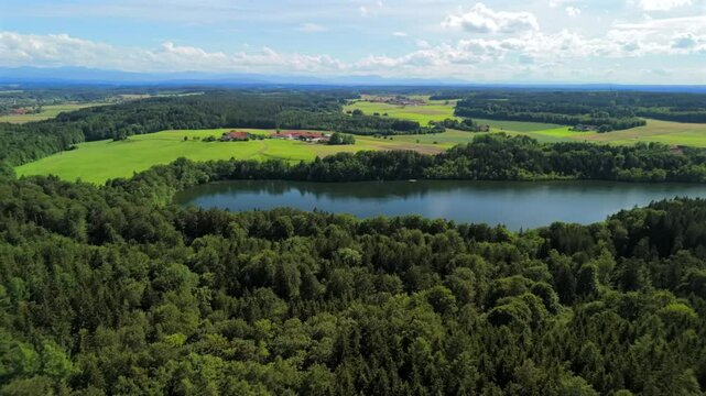 Steinsee bei Munchen Luftaufnahme. Steinsee, See in Bayern Luftbildansicht. Lake Stein aerial view near Munich, Bavaria, Germany. One of warmest lakes in Germany. Steinsee is located in forest area. 