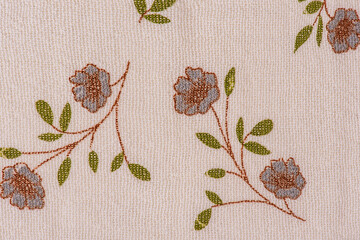 Light beige fabric with gray flowers with brown and green petals.