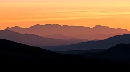 Fototapeta premium Silhouetted Mountains at Sunset Golden Hues