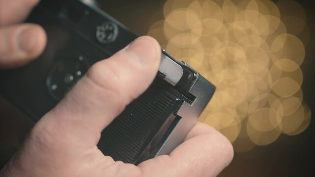 Vintage film camera mechanical shutter cocking by hand close up, retro photography mechanism