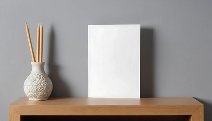front view of blank greeting card on bookshelf and grey wall