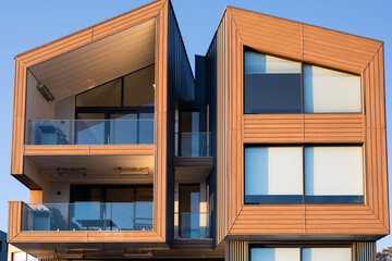 newly constructed apartment building block house home residential blue sky