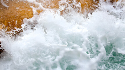 Ocean wave foam closeup, turquoise water, rocky shore background. Perfect for website or travel brochure design