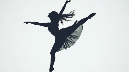 Silhouette of a graceful dancer leaping against a minimalist backdrop with flowing fabric
