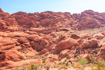 A rocky mountain range with a clear blue sky in the background