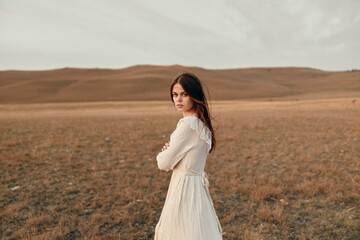 Serenity at sunset woman in white dress standing in open field for beauty and nature lovers