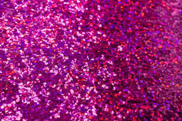 Full frame macro abstract texture background of a sparkling rosy pink color glitter surface

