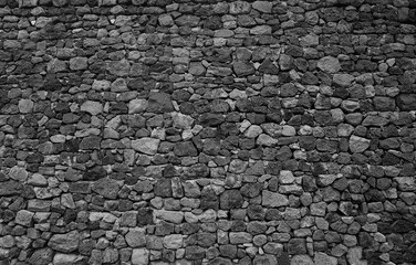 Old historical stone wall background texture close up. Texture pattern of stone fence. aged castle...