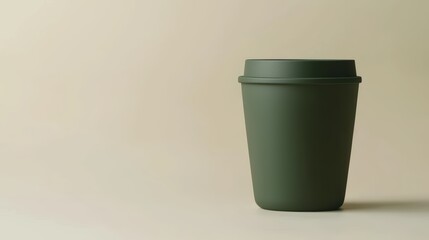 A simple green cup stands against a soft beige background, showcasing a minimalist and modern design as mock-up.