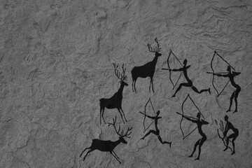 Parietal art or cave painting depicting group or tribe of Stone age people or hunters hunting deers...