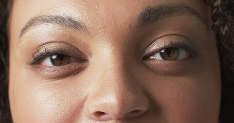 Biracial beautiful plus size woman smiling warmly with eyes closed