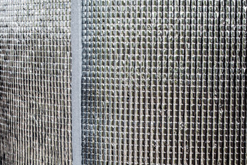 Heat insulating aluminum sheet. Insulates from outside heat and retains coolness. Silver rolls material building materials in a hardware store. close-up, foil film.