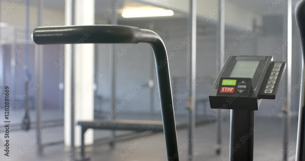 Poster exercise bike in gym with digital display showing start and stop buttons
