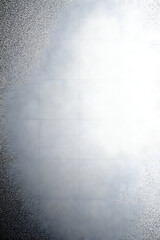 A textured background featuring a blend of light and dark areas, with a prominent white cloud-like formation in the center.