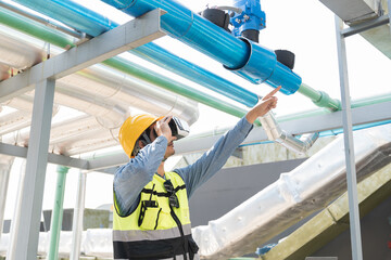 Male engineer using virtual reality headset at construction site. Male plumber wearing virtual...