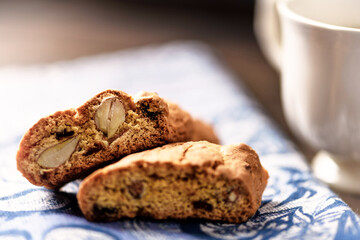 Cantuccini (Italian cookie) and a cup of coffee on dark wooden background. Close up.