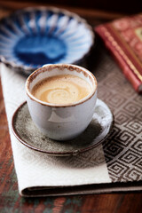 Cup of coffee on wooden background. Soft focus. 